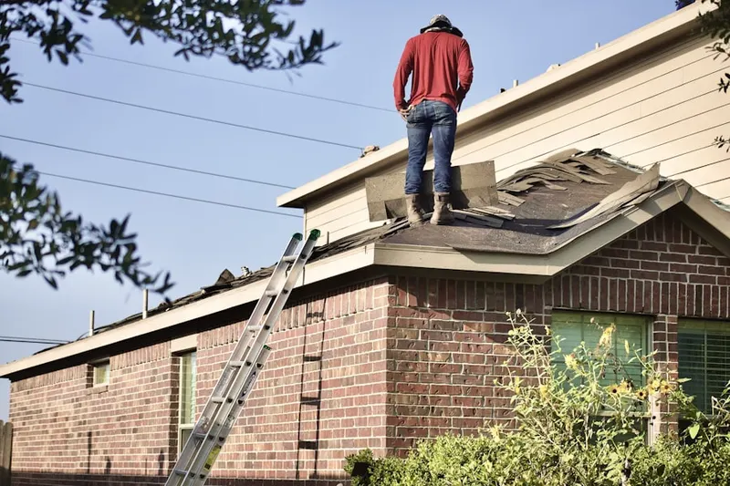 Professional roofer working on a residential roof in Great Falls